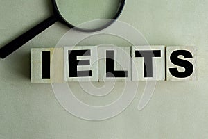 Concept of The wooden Cubes with the word IELTS on wooden background