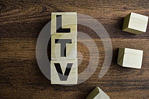 Concept of The wooden Cubes with the word LTV - Life Time Value on wooden background