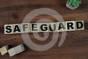 Concept of The wooden Cubes with the word Safeguard on wooden background