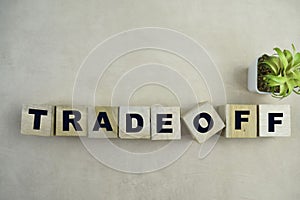 Concept of The wooden Cubes with the word Tradeoff on wooden background