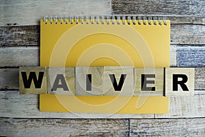 Concept of The wooden Cubes with the word Waiver on wooden background photo