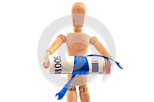 Concept with wooden toy with rolled paper euro money