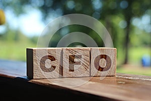 Concept word CFO on cubes on a wooden background