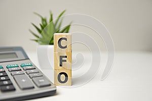 Concept word CFO on cubes on a wooden background