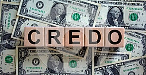 Concept word `credo` on cubes on a beautiful background from dollar bills. Business concept