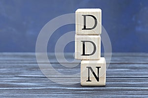 Concept word DDN on cubes on a beautiful gray blue background