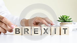 concept word forming with cube on wooden desk background - Brexit
