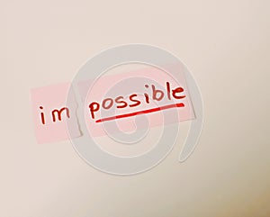 Concept of the word impossible written by hand