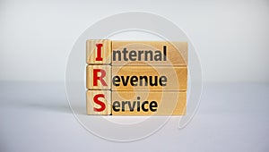 Concept word `IRS - Internal Revenue Service` on wooden cubes and blocks on a beautiful white background. Business concept, copy photo