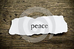 Concept word on paper on wooden desk - Peace