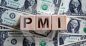 Concept word `PMI` on cubes on a beautiful background from dollar bills. Business concept photo