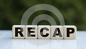 The concept of the word RECAP on cubes on a beautiful green background photo