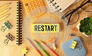 The concept word Restart on wooden cubes. Beautiful orange table, orange background, copy space