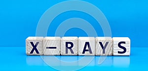 concept word X-RAYS on cubes on a blue background