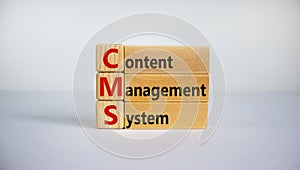 Concept words `CMS, content management system` on cubes and blocks on a beautiful white background. Copy space, business concept