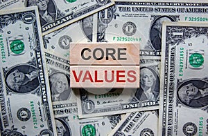 Concept words `core values` on wooden blocks on a beautiful background from dollar bills. Business concept