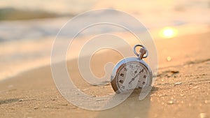 Concept work balance. Vintage retro stopwatch lay on beach, ticking. baby run and stepped on watch with foot. there is