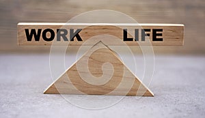 Concept of work-life balance on wooden scales