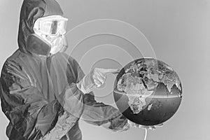 Concept: world viral crisis. Woman in lab coat, nitrile gloves, goggles, face mask, and NBC suit for covid-19 coronavirus, negativ