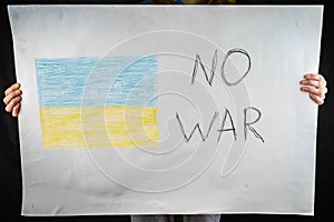 The concept of the World without war, the flag of Ukraine drawn with chalk on paper and the inscription calling to stop