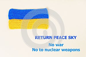 The concept of the World without war, Knitted flag of Ukraine and the inscription calling to stop the war