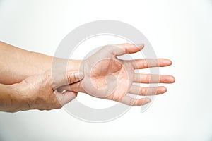 Concept wrist symptomatic Office Syndrome,Asian man hand holding his pain wrist  on background,Chronic wrist inflammation