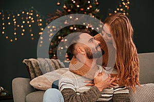 Conception of love. Young couple are celebrating New Year at home