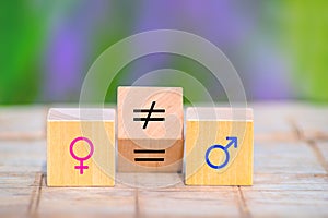Concepts of gender equality.  Wooden cube with symbol unequal change to equal sign