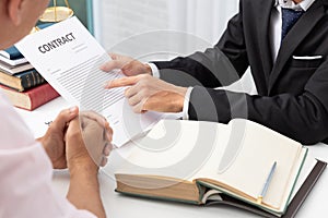 Concepts of law, Lawyer and businessman working and discussing business contract papers in office