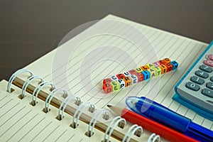 Conceptual of accumulated depreciation in financial statements. Colorful alphabet beads stacked forming the words over dark table