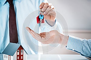 Conceptual Agent Giving House Key to a Buyer