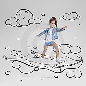 Conceptual artwork. Little girl flying on drawn carpet. Inspiration world for kids. Concept of ideas, imagination