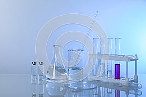Conceptual background with chemical flasks and lab glassware.