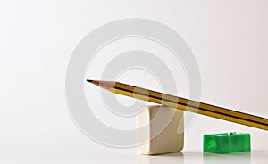 Conceptual background of teaching schools with pencil eraser and sharpener