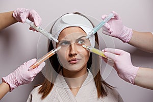 Conceptual beauty and cosmetology image of the hands of several beauticians holding their respective equipment. Beauty