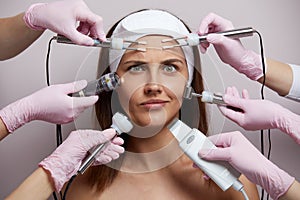 Conceptual beauty and cosmetology image of the hands of several beauticians holding their respective equipment. Beauty