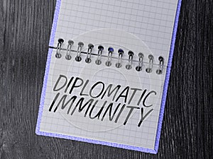 Conceptual caption Diplomatic Immunity. Word Written on law that gives foreign diplomats special rights in the country