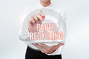 Conceptual caption Paper Recycling. Business overview Using the waste papers in a new way by recycling them Presenting