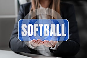 Conceptual caption Softball. Internet Concept a sport similar to baseball played with a ball and bat photo