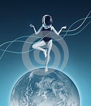 Conceptual creative artwork with young girl in helmet standing on planet on outer space background. Concept of astronautics,