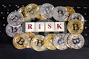 Conceptual cryptocurrency bitcoin on computer keyboard word Risk