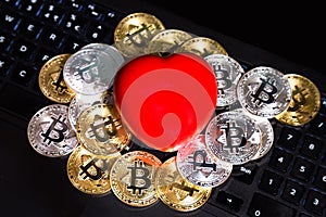 Conceptual cryptocurrency bitcoin with red heart denoting love