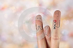 Conceptual family finger art. Father and son are giving flowers his mother. Stock Image