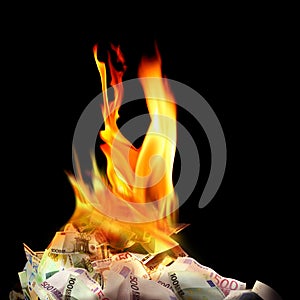 Conceptual finance image of burning pile of money, dollar and eu