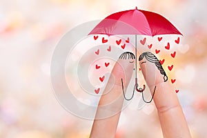 Conceptual finger art of a Happy couple. Lovers are kissing under umbrella. Stock Image