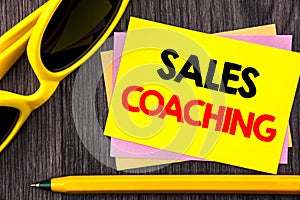 Conceptual hand text showing Sales Coaching. Business photo showcasing Business Goal Achievement Mentoring written on Stiky Note P