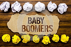 Conceptual hand text word Baby Boomers. Business concept for Demographic Generation Written on sticky note, wooden with sticky, ma