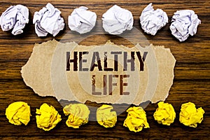 Conceptual hand text word Healthy Life. Business concept for Good Health Food Written on sticky note, wooden with sticky, many fol