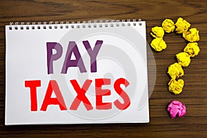Conceptual hand writing caption inspiration showing Pay Taxes. Business concept for Taxation Overtax Return written on notepad not