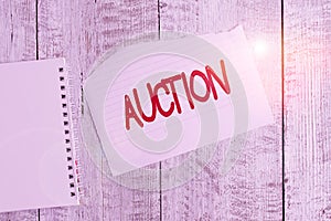 Conceptual hand writing showing Auction. Business photo text Public sale Goods or Property sold to highest bidder Purchase Torn